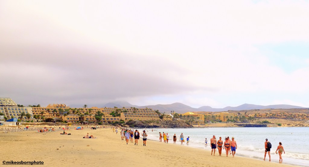 Holidaymakers walk along the shore at the resort of Costa Calma in Fuerteventura.