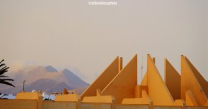 The concrete peaks of the Taro Beach hotel alongside the mountains of southern Fuerteventura.