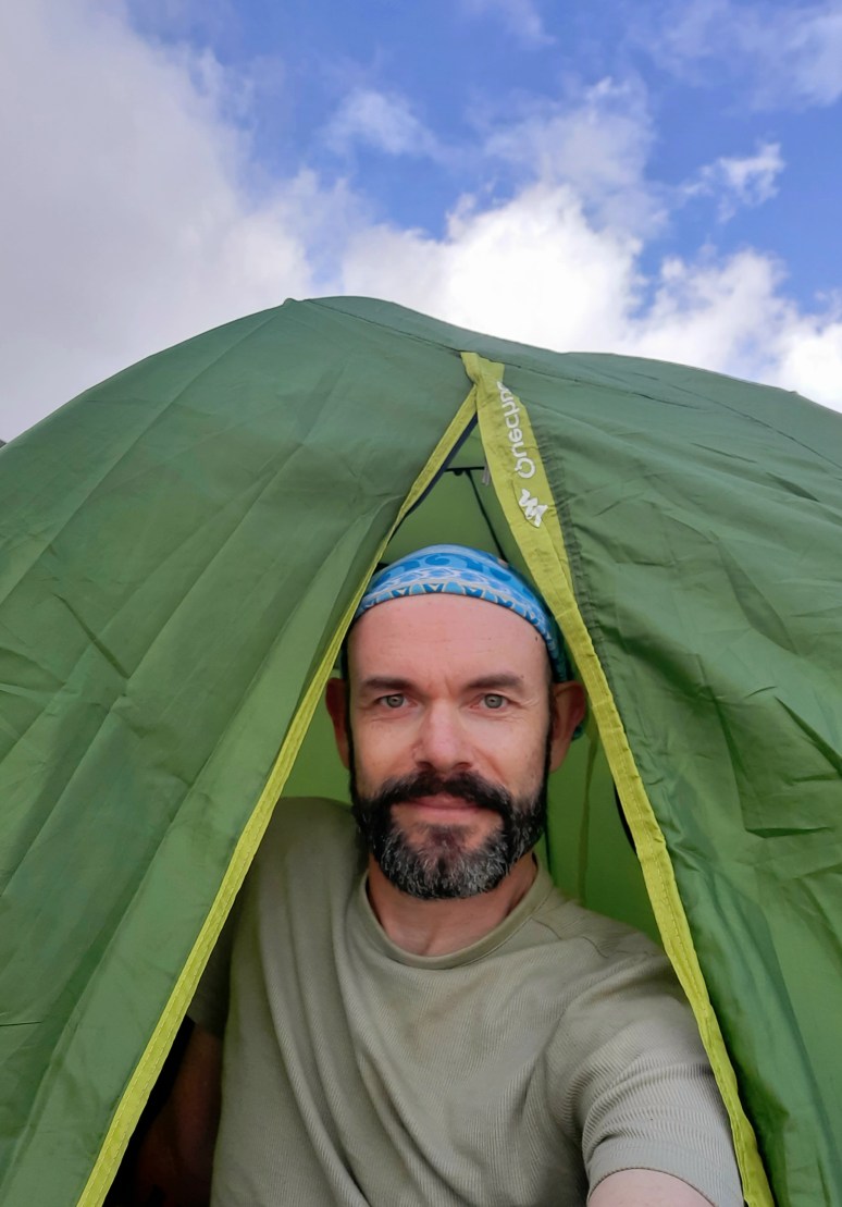 Author Mike Osborn in his tent on a trip to volcano Mount Karthala in the Comoros.