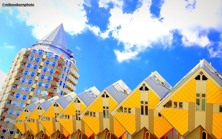A conical tower block and famous yellow of the Cube Houses in Rotterdam, Netherlands.