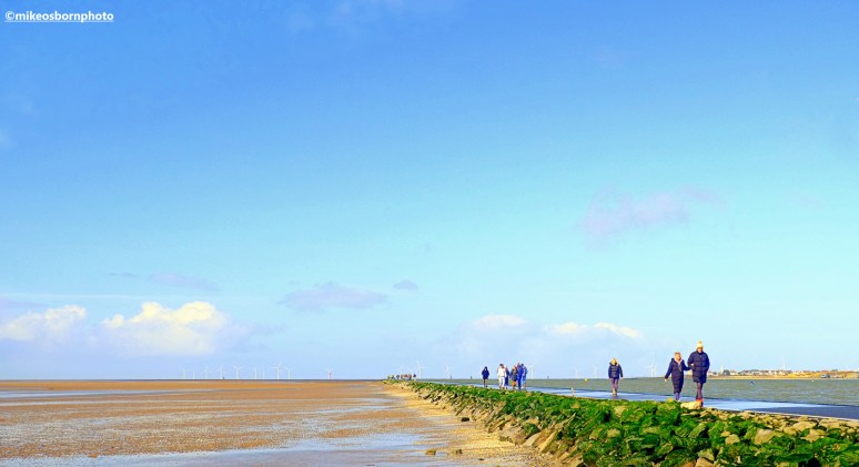 Walkers enjoy an early Spring walk around the Marine Lake path in West Kirby, Wirral.