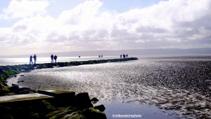 Walkers on the path next to West Kirby's Marine Lake on the Wirral near Liverpool.
