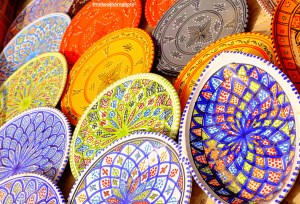 Brightly coloured ceramics on display in the old market of Houmt Souk in Djerba, Tunisia.