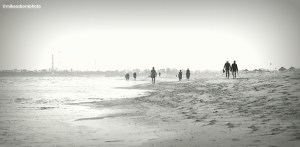 Holidaymakers walking along the seashore of Djerba in Tunisia.