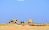 A collection of abandoned sand-coloured buildings close to the beach on the Tunisian island of Djerba,