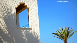 The textured whitewash and ornate window of the Iberostar Waves Mehari hotel in Djerba, Tunisia.