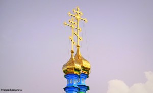 Ornate gold crosses and cupolas on the Orthodox cathedral of Karakol in Kyrgyzstan.