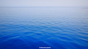 An expanse of calm dark blue water on Issyk-Kul lake in Kyrgyzstan.