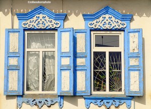 A pair of vintage Russian-style windows and shutters in the Kyrgyz city of Karakol.