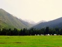 A yurt encampment nestling in the mountainous landscape of Kyrgyzstan.