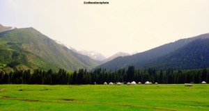 A yurt encampment nestling in the mountainous landscape of Kyrgyzstan.