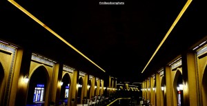 A modern outdoor shopping mall in the Kazakh city of Turkistan lit up after dark.