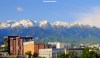 The snow-capped Tien Shan mountains overlooking buildings in Almaty, Kazakhstan.