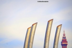 The Blackpool Tower is dwarfed by elegant metalwork on the approach to the seaside town's promenade.