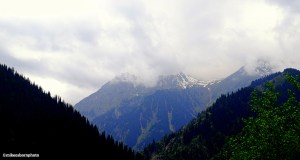 Cloud-capped mountain tops seen in the landscape of Kazakhstan.