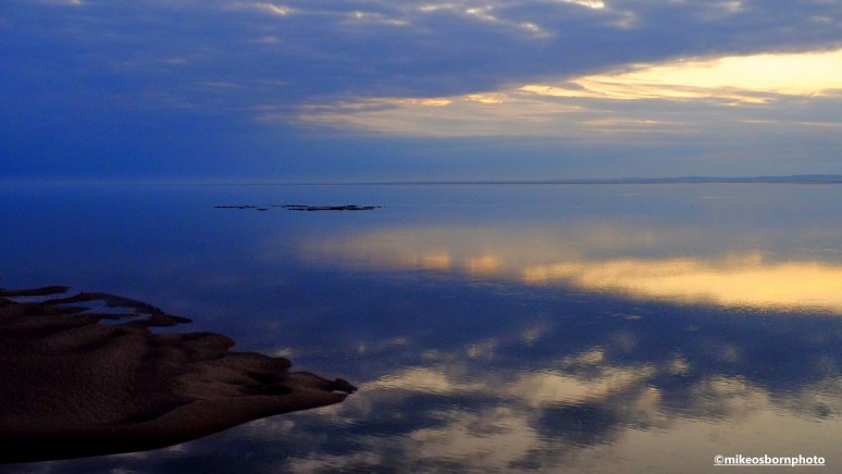 The last of the sunlight reflecting on the water of Morecambe Bay in Lancashire.