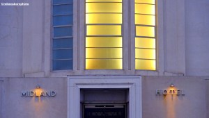 The illuminated entrance to Morecambe's iconic Midland Hotel captured at dawn.