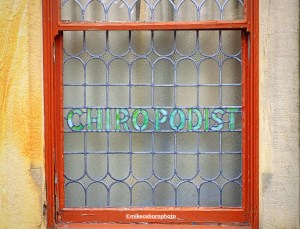An old window advertising a chiropody business on Yorkshire Street in Morecambe, Lancashire.