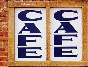 A double sign for the cafe on Morecambe's stone jetty in Lancashire.