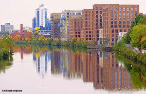New residential housing blocks reflected in the waters of the Manchester Ship Canal at Ordsall in Salford.