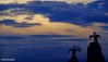 A deep blue and golden dusk captured with the stone cormorant statues on Morecambe's stone jetty.