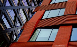 Contrasting dark and terracotta office buildings in the New Bailey area of Manchester.