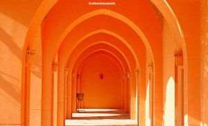 The arches of an ochre covered walkway in the downtown area of El Gouna in Egypt.